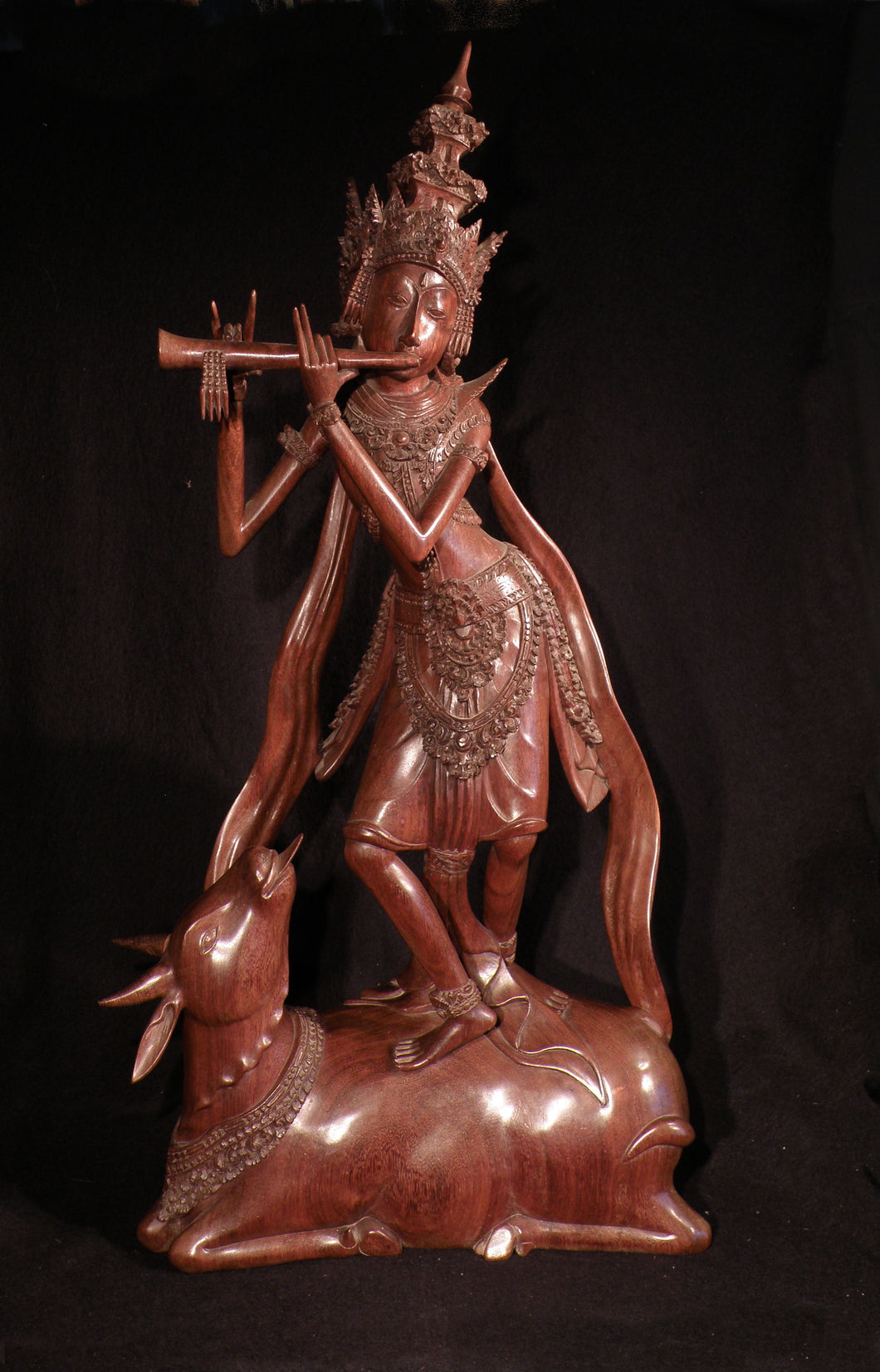 Krishna playing the flute on Nandi